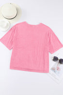 Haut à épaules tombantes et col rond avec poche